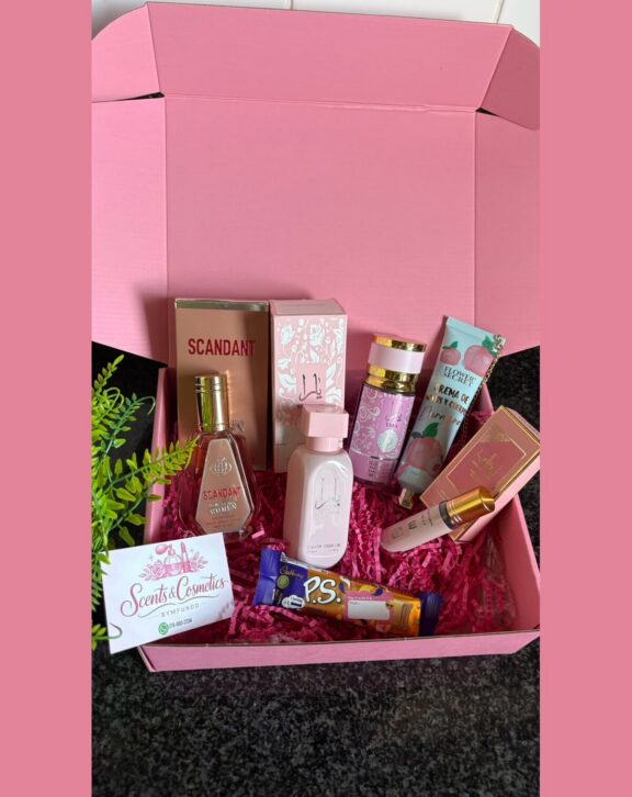 A packed pink gift box built around a perfume.