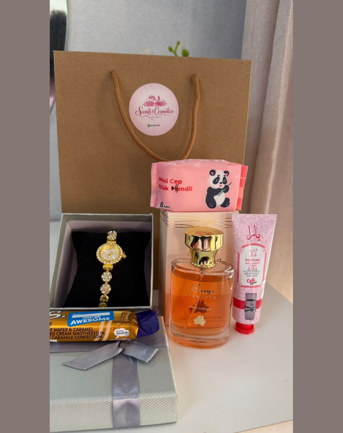 Boxed crystal watch with a perfume and hand cream.