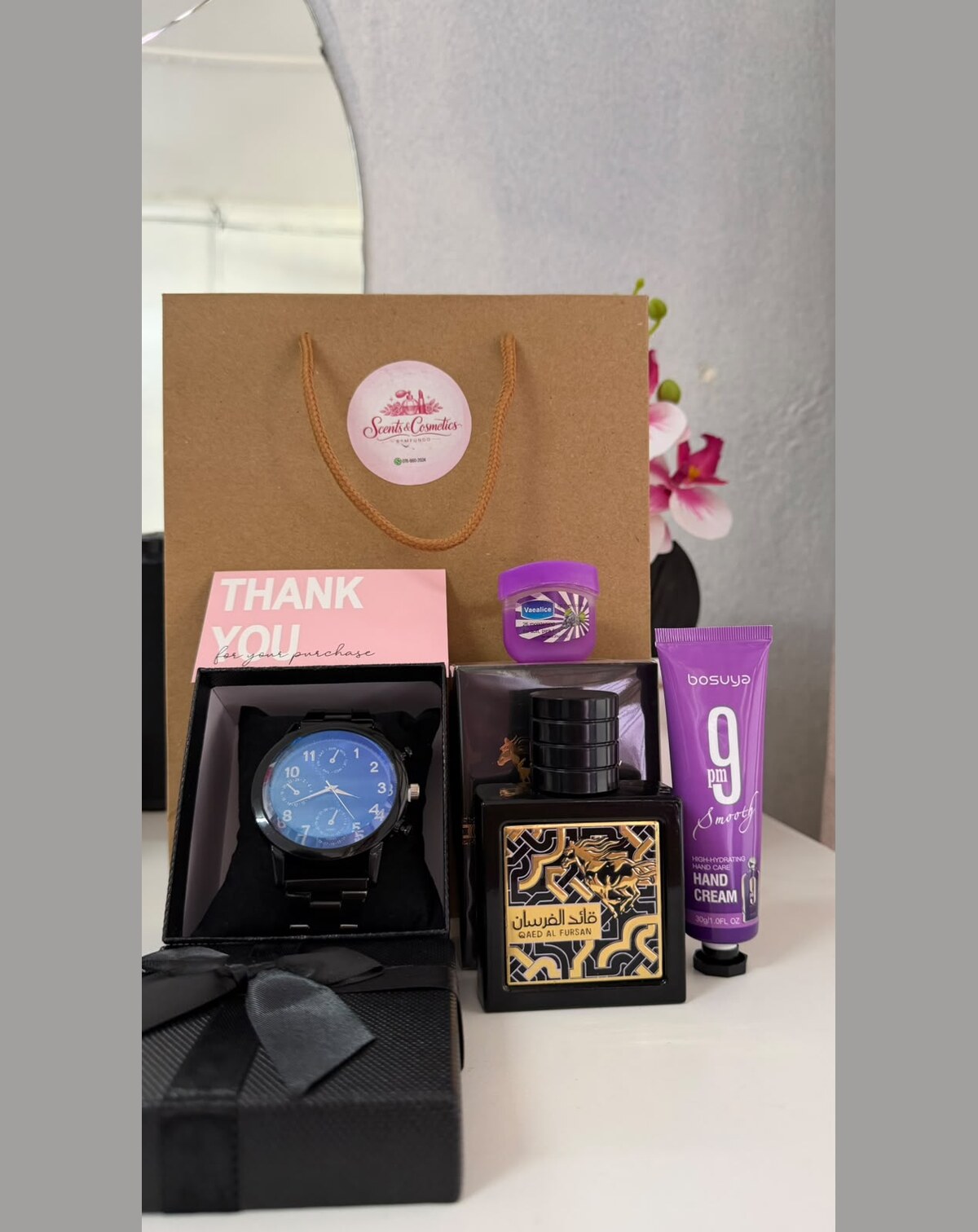 Boxed watch with an eau de parfum and hand cream.