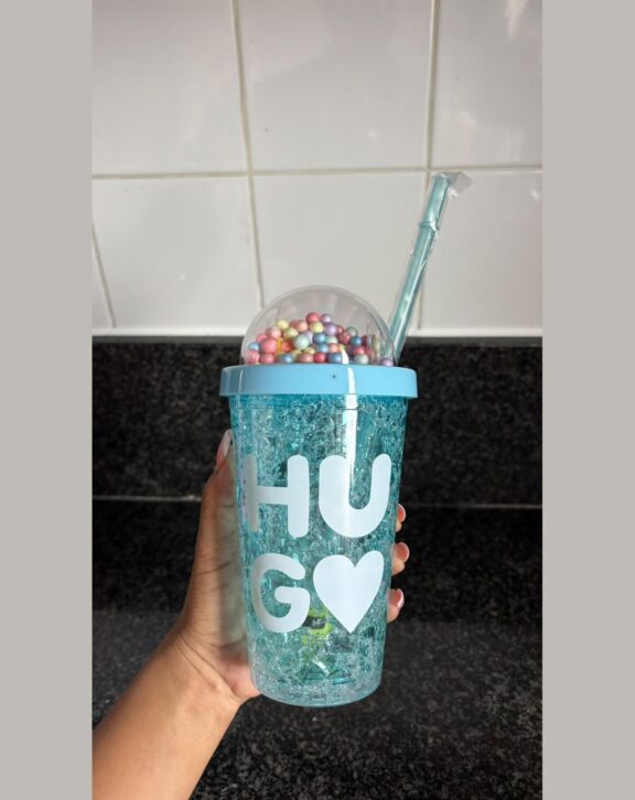 Double-wall freezer tumbler with dome lid and straw.