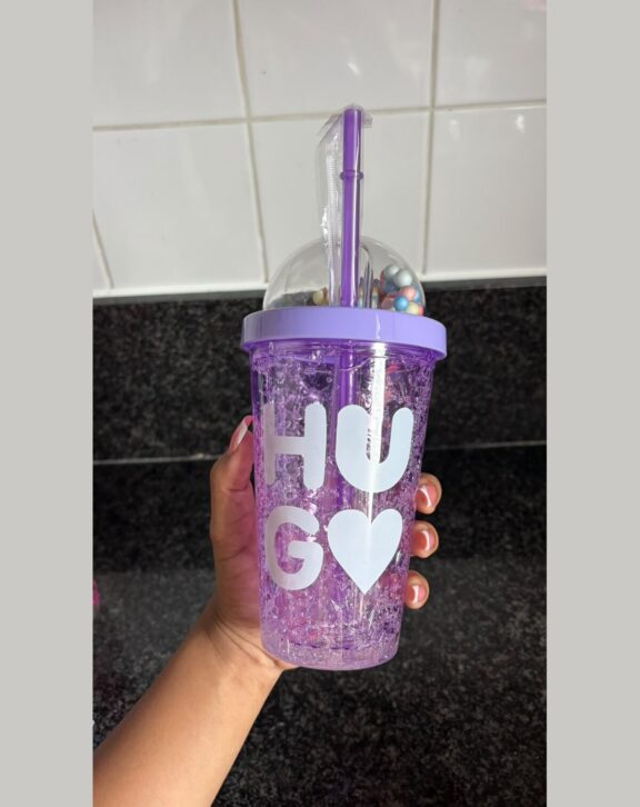 Double-wall freezer tumbler with dome lid and straw.