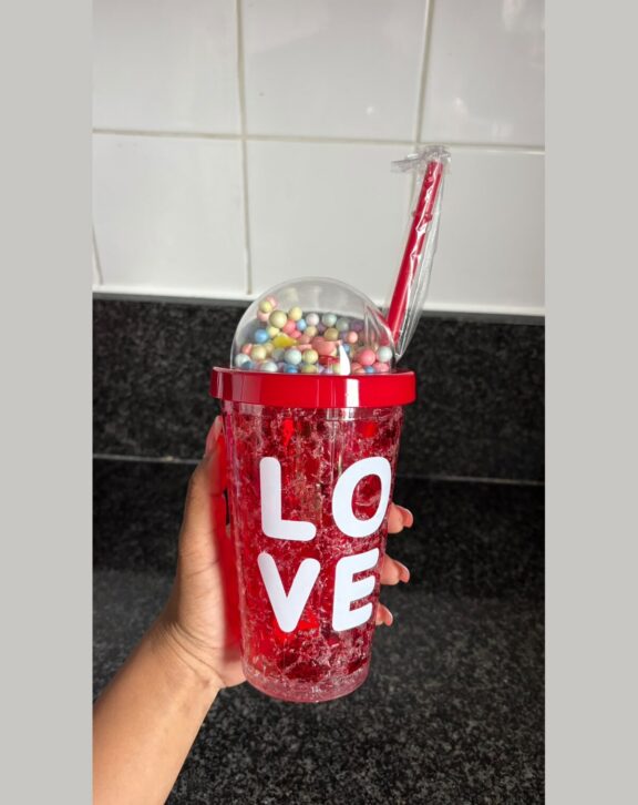 Double-wall freezer tumbler with dome lid and straw.
